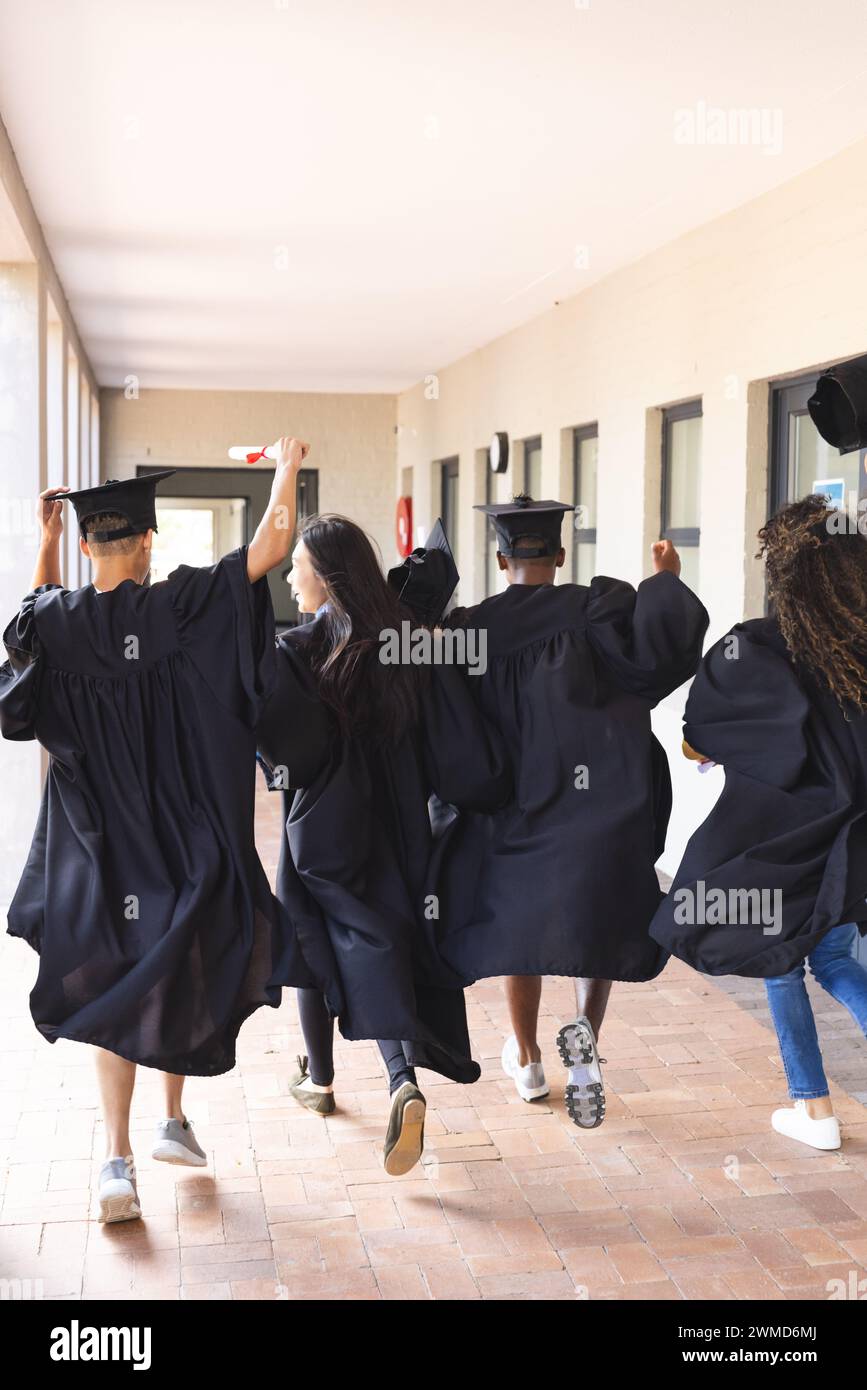 Diverse students celebrate graduation at high school with copy space Stock Photo
