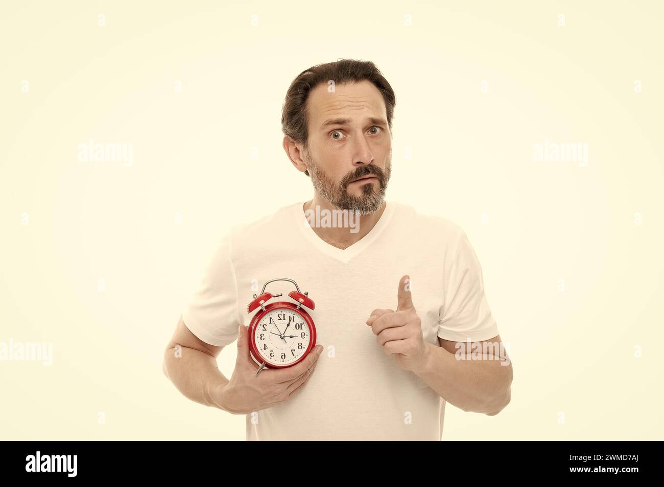confused man with alarm clock isolated on white. man with alarm clock ...