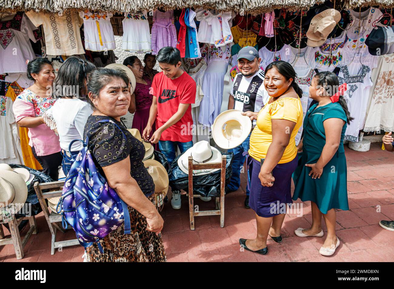 Merida Mexico,Uxmal,souvenir vendors,women men boys girls,display sale,hats fedoras clothing,visiting family families parent parents father mother,son Stock Photo