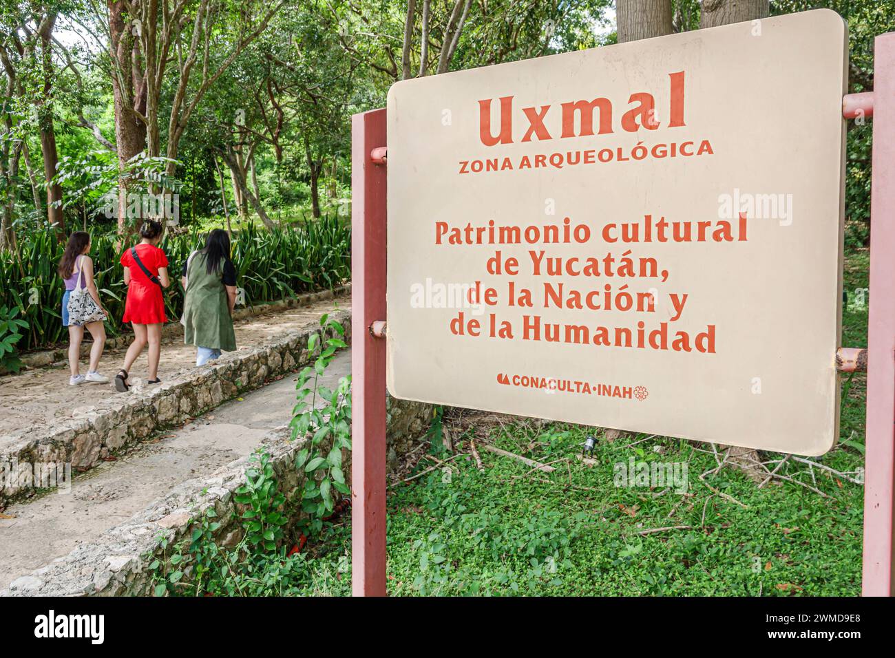 Merida Mexico,Puuc style Uxmal Archaeological Zone Site,Zona Arqueologica de Uxmal,classic Mayan city,entrance sign,arriving visitors woman women lady Stock Photo