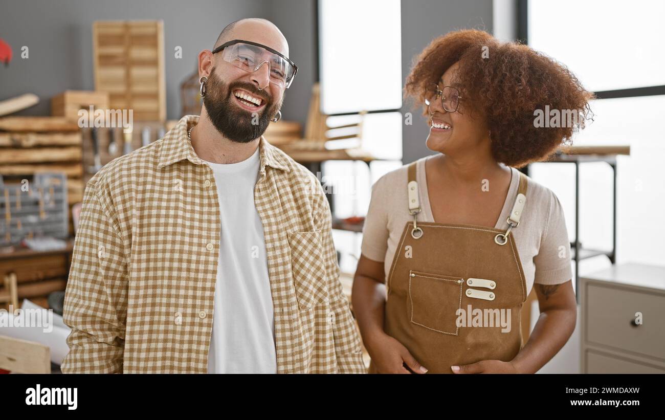 Two smiling carpenters, clad in safety glasses, standing united at