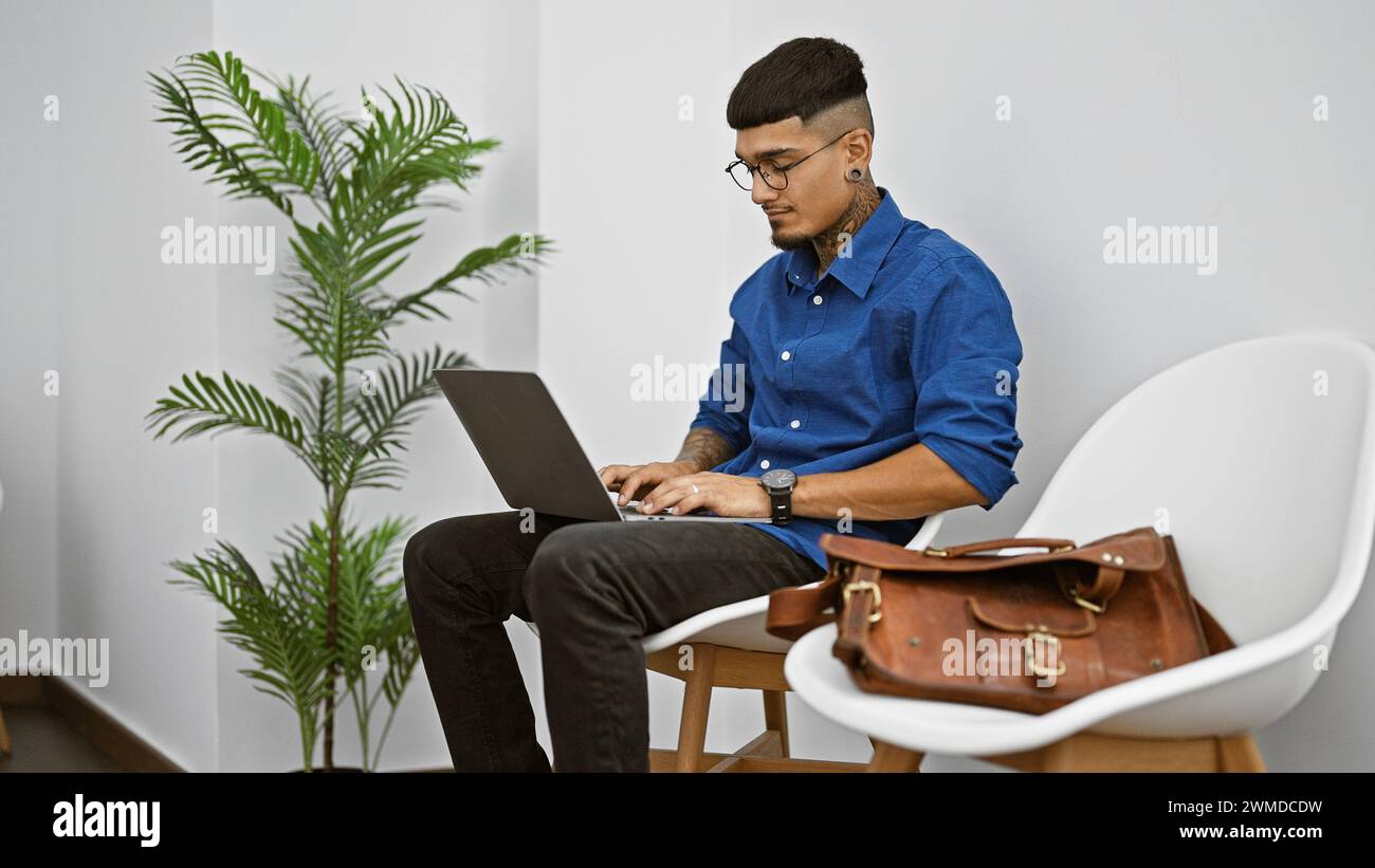 Serious young latin man, a tattooed professional, doubtfully ...