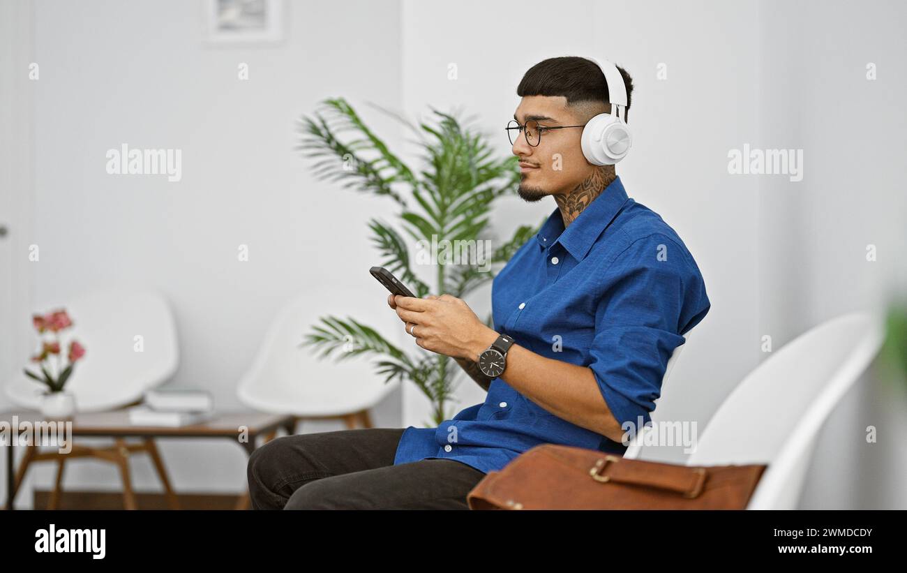 Young latin man, engrossed in his phone, tapping to the rhythm echoing