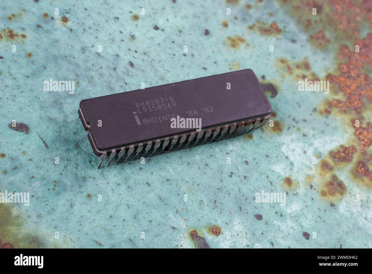 KYIV, UKRAINE - August 2, 2023. Intel 287 floating point unit coprocessor unit on rusty background. Stock Photo