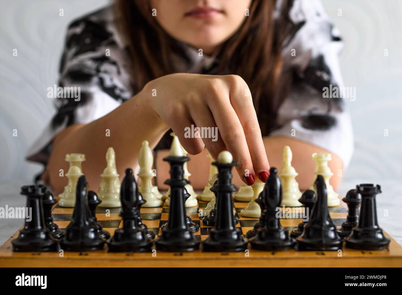 Young lady woman playing chess Stock Photo