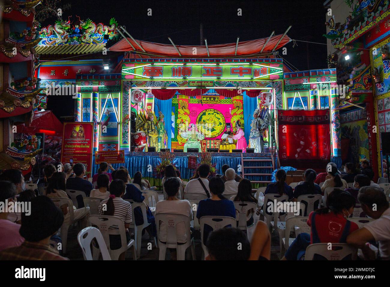People watch Chinese opera performance during the birthday celebration ...