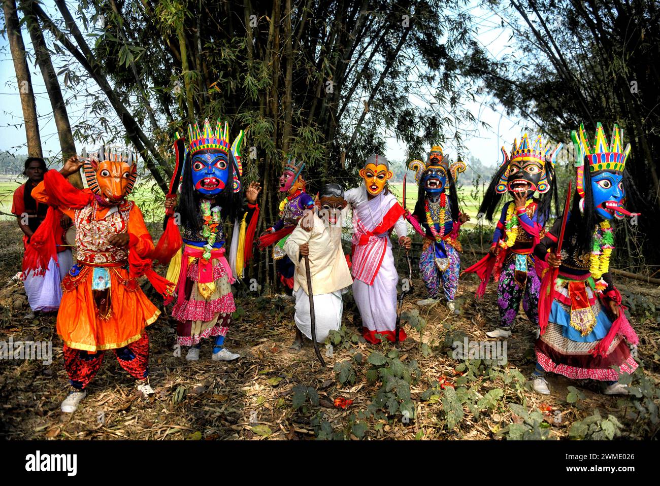 Masked dancers of Gomira dance troupe perform at a village near Raiganj. Gomira is a masked dance form. The word ‘Gomira' has been derived from the colloquial form of the word ‘Gram-Chandi' or the female deity who is the protective force of the village. The exact origin of the dance form is not traceable and the knowledge has been lost over time. Gomira dance is a rural dance form mainly practiced in the Dinajpur district of West Bengal. The Gomira dances are organized to appease the deity to usher in the 'good forces' and drive out the 'evil forces'. It is usually organised during mid-Februar Stock Photo