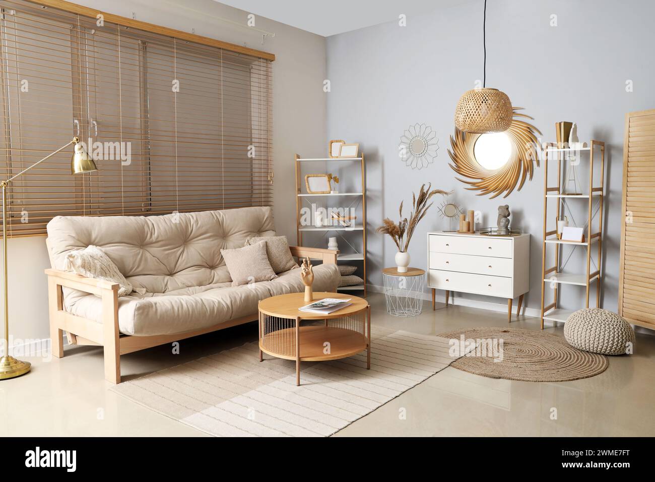 Interior of stylish living room with golden mirror, commode and sofa ...