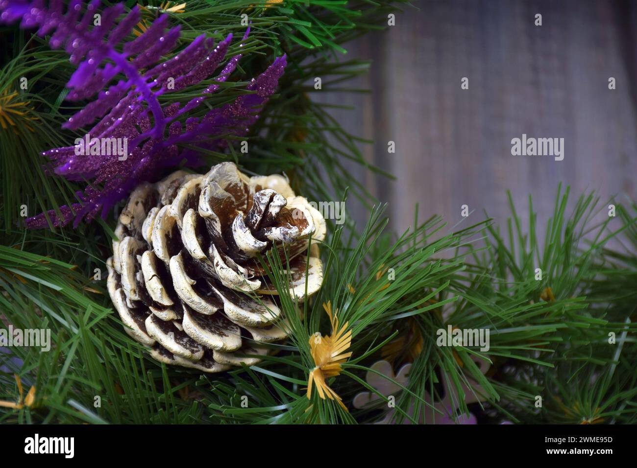 Christmas decor, close-up. A festive wreath on an old wooden door. Christmas traditions. Comfort. Family values. Stock Photo
