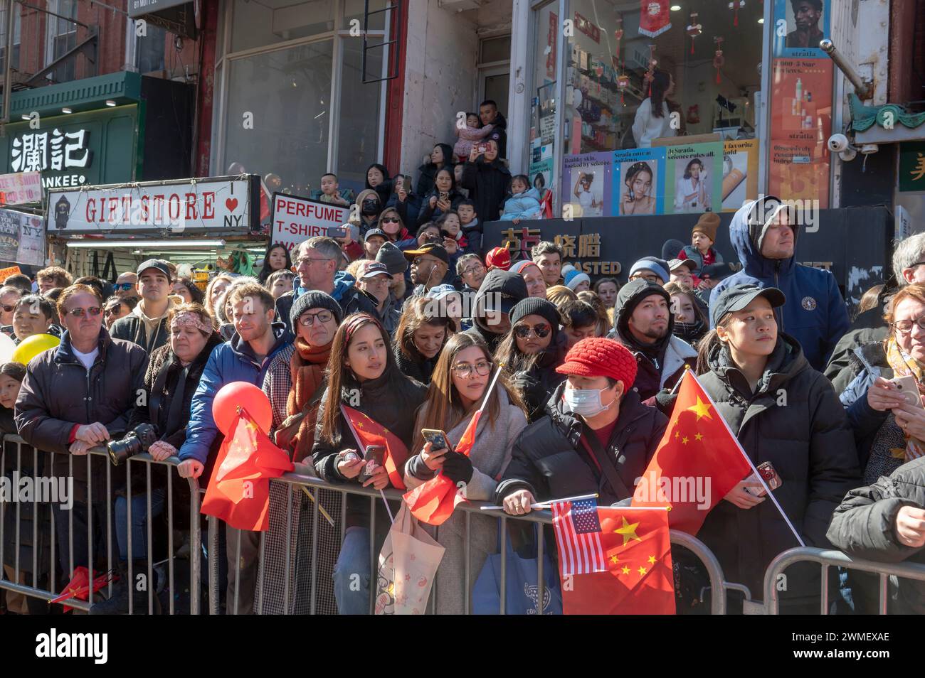 New York, United States. 25th Feb, 2024. NEW YORK, NEW YORK - FEBRUARY 25: Spectators watch the annual Lunar New Year parade in Chinatown on February 25, 2024 in New York City. People gathered to enjoy and celebrate the 26th annual Lunar New Year parade, commemorating the end of the 15 days honoring the first new moon on the lunar calendar. 2024 is the 'Year of the Dragon.' Credit: Ron Adar/Alamy Live News Stock Photo