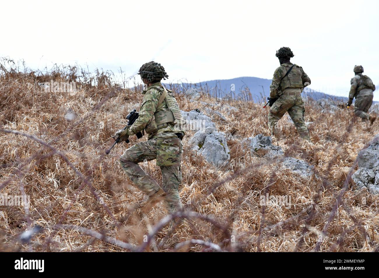U.S. Army Paratroopers assigned to the 1st Battalion, 503rd Infantry Regiment, 173rd Airborne Brigade, move toward an objective during team blank-fire and tactical movement training  as part of Eagle Ursa at the training range in Slunj, Croatia, Feb. 24, 2024. The 173rd Airborne Brigade is the U.S. Army's Contingency Response Force in Europe, providing rapidly deployable forces to the United States European, African, and Central Command areas of responsibility. Forward deployed across Italy and Germany, the brigade routinely trains alongside NATO allies and partners to build partnerships and s Stock Photo