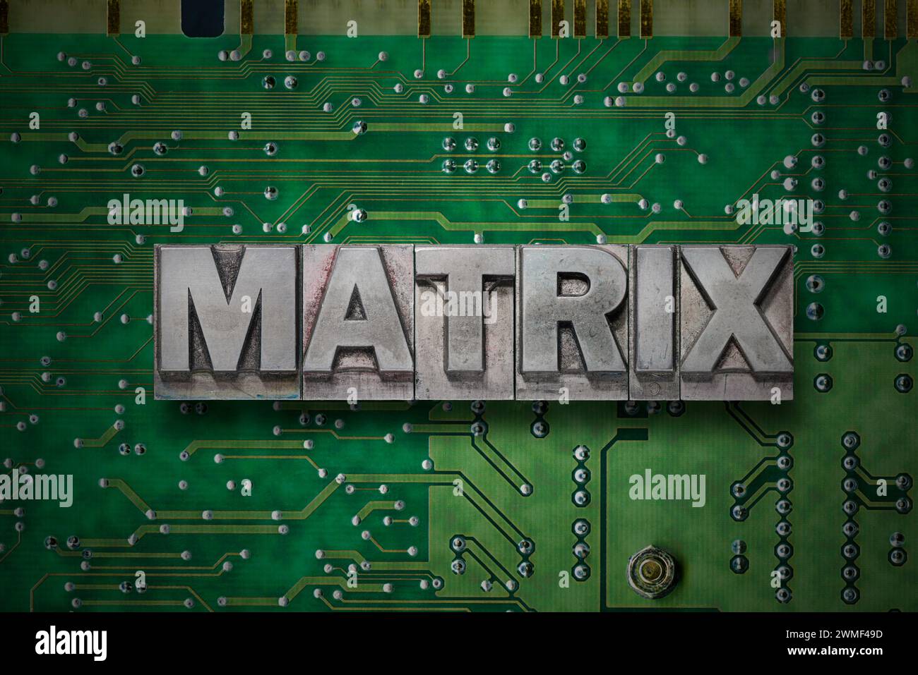 matrix word made from metallic letterpress blocks on the green pc board background Stock Photo