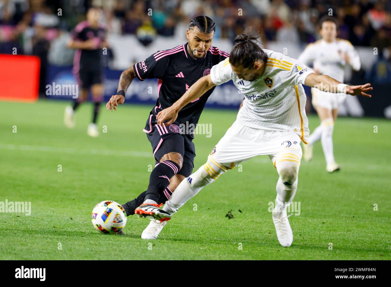 Los Angeles, California, USA. 25th Feb, 2024. LA Galaxy's MartÃ-n CÃ¡ceres #22 and Inter Miami's DeAndre Yedlin #2 vie for the ball during an MLS soccer match at Dignity Health Sports Park, Feb. 25 2024, in Carson, Calif. (Credit Image: © Ringo Chiu/ZUMA Press Wire) EDITORIAL USAGE ONLY! Not for Commercial USAGE! Credit: ZUMA Press, Inc./Alamy Live News Stock Photo