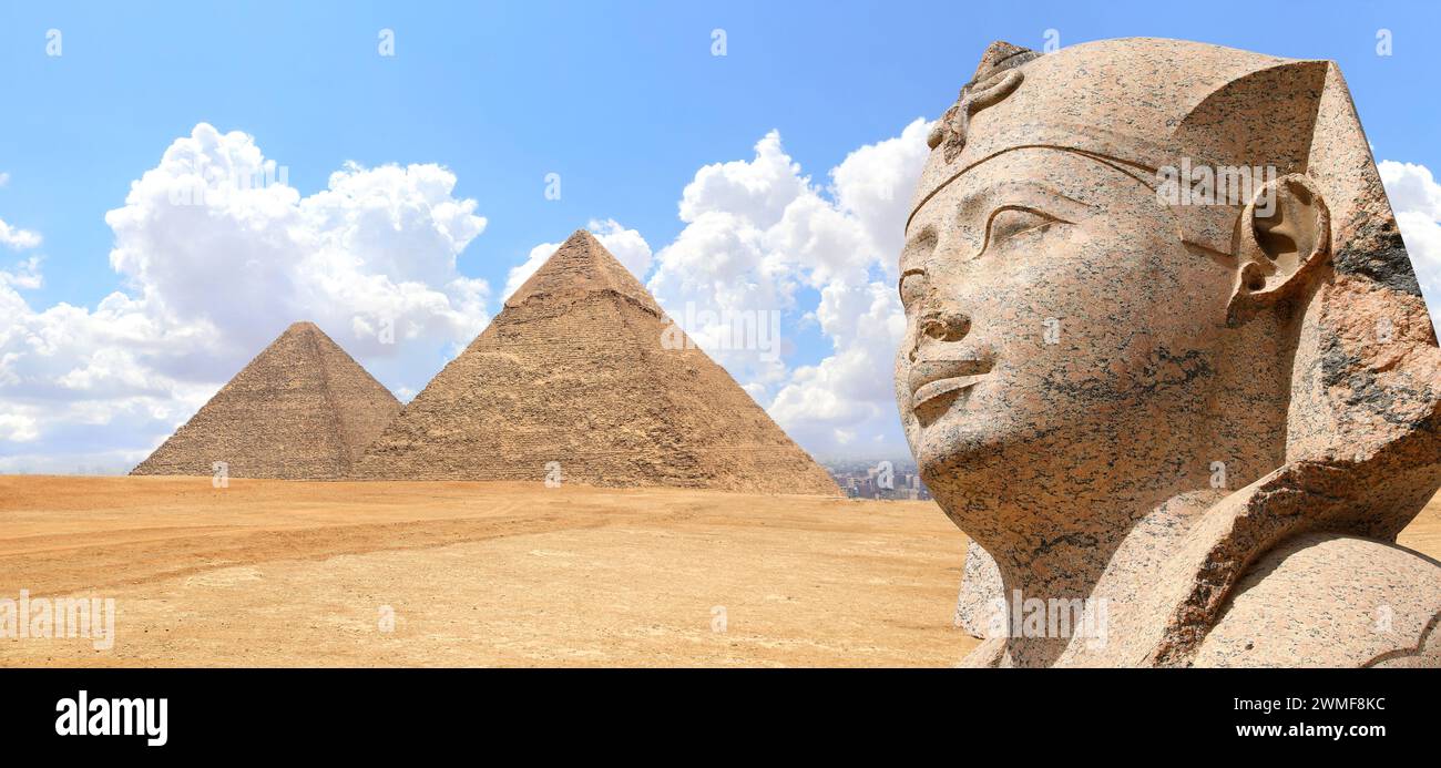 Horizontal banner with stone sphinx statue and famous Great Pyramids of Chephren and Cheops, Giza pyramid complex (Giza Necropolis), Cairo, Egypt. Two Stock Photo