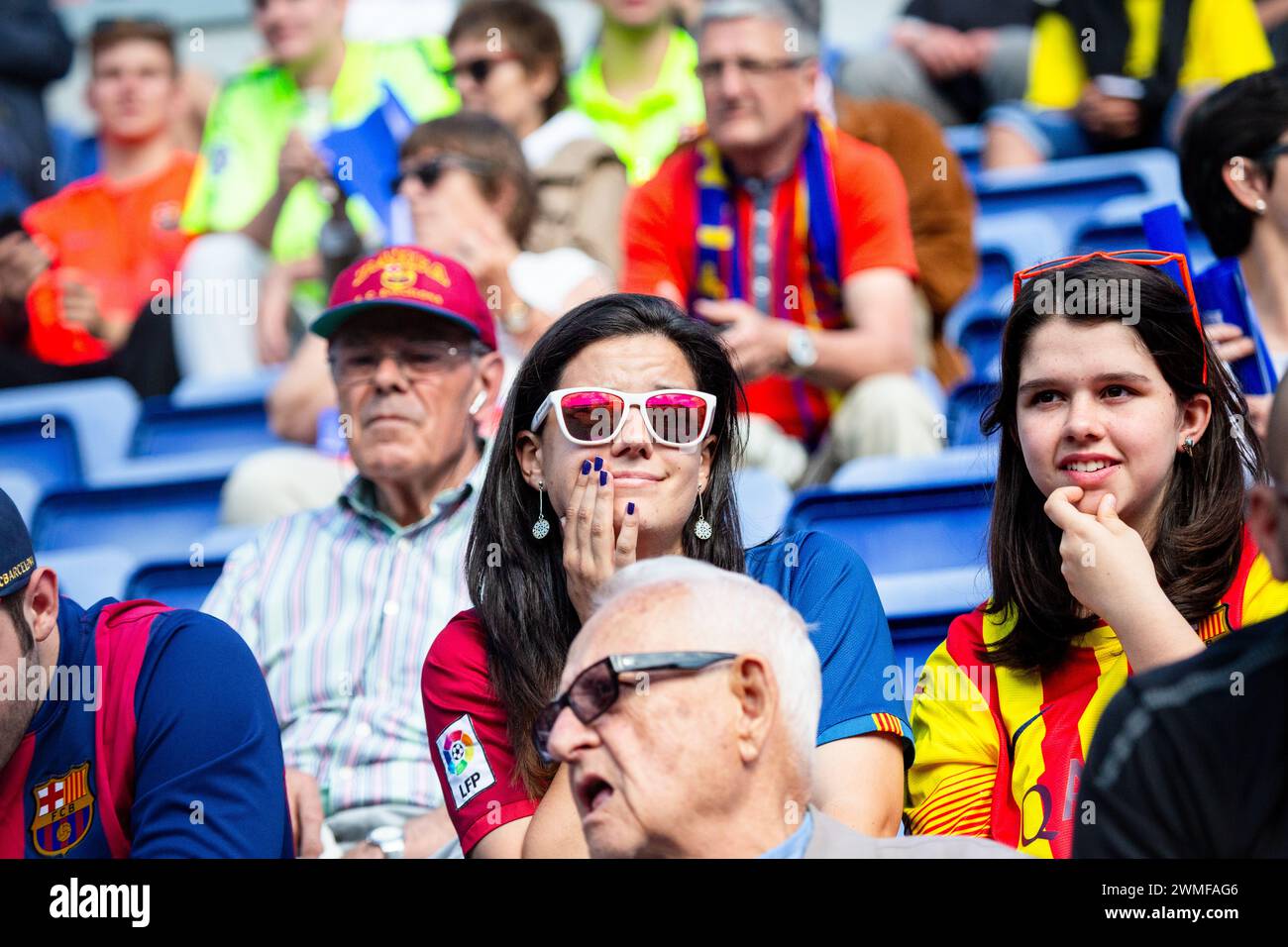FANS, BARCELONA FC, 2015: Two young female fans in the crowd. Fans gather at Camp Nou before match. The final game of the La Liga 2014-15 season in Spain between Barcelona FC and Deportivo de La Coruna at Camp Nou, Barcelona on May 23 2015. The Game finished 2-2. Barcelona celebrated winning the championship title and legend Xavi's final home game. Deportiva got the point they needed to avoid relegation. Photograph: Rob Watkins Stock Photo