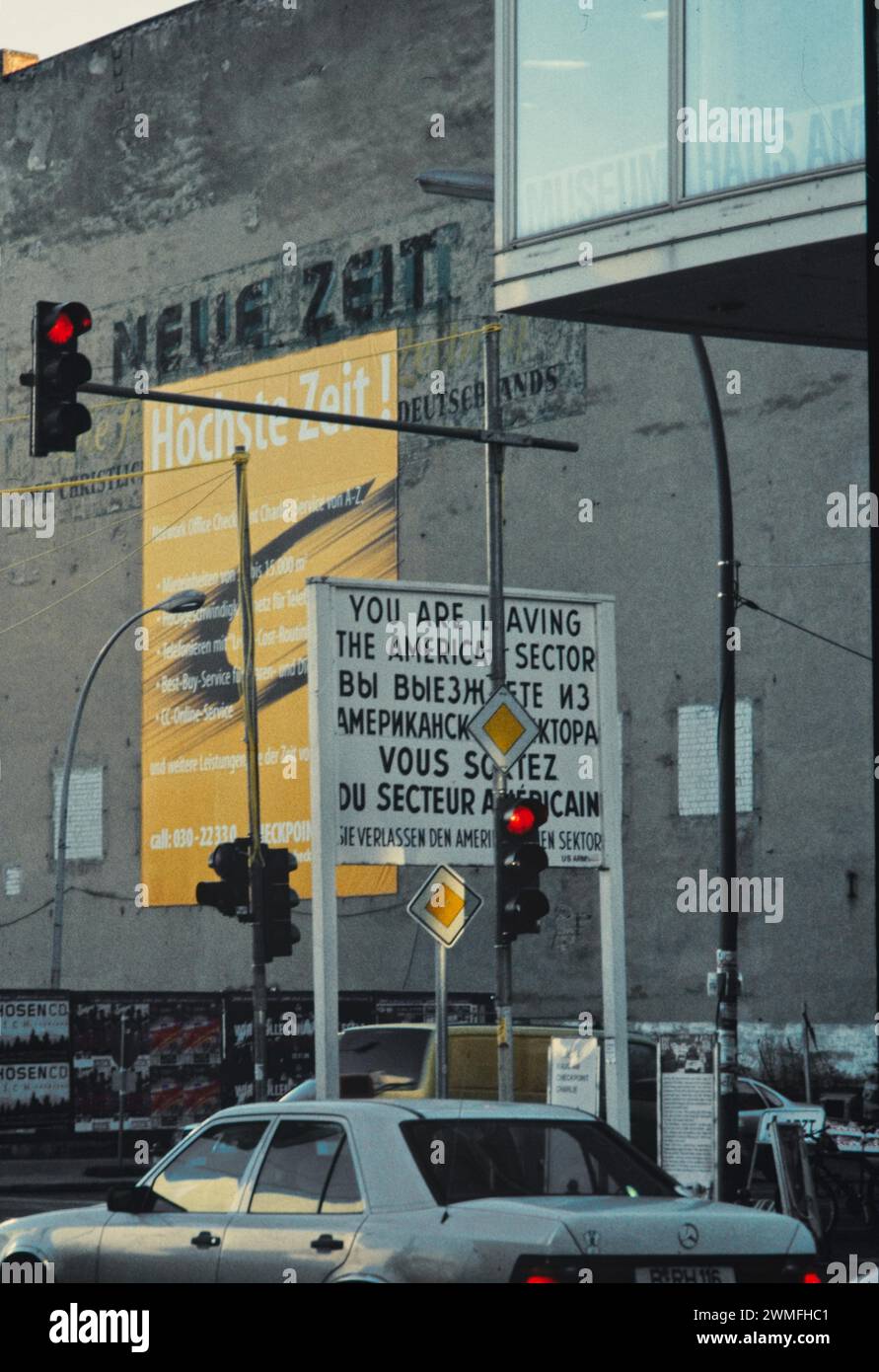 Checkpoint Charlie with building of the Union-Druckerei, a company of the CDU of the GDR, on whose facade old newspaper advertisements can still be Stock Photo