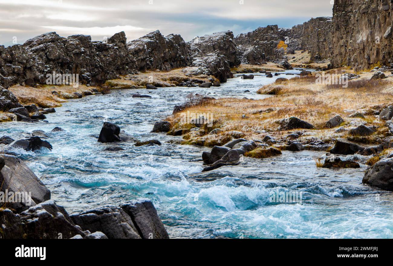 River Surrounded By Rocks Picturesque view of fast flowing river surrounded with rock formations ...