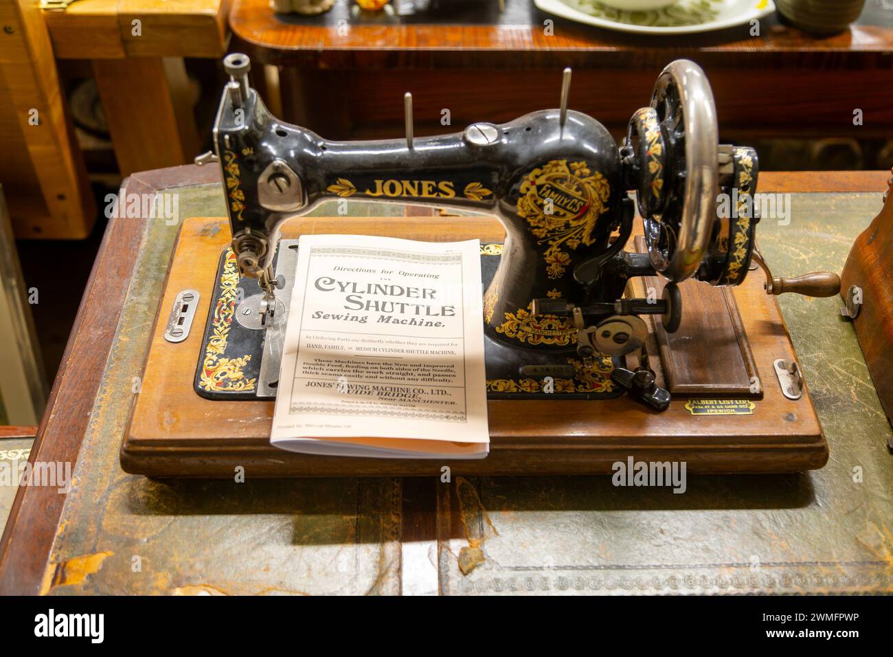 Jones Sewing Machine Company Family Cylinder Shuttle model with instruction manual on display in auction room, UK Stock Photo