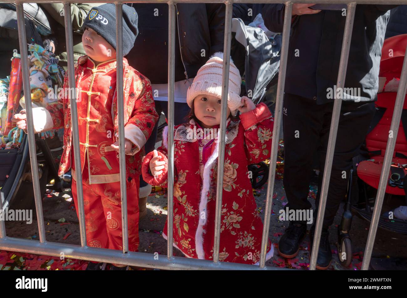 New York, United States. 25th Feb, 2024. Children watch the annual Lunar New Year parade in Chinatown on February 25, 2024 in New York City. People gathered to enjoy and celebrate the 26th annual Lunar New Year parade, commemorating the end of the 15 days honoring the first new moon on the lunar calendar. 2024 is the 'Year of the Dragon.' (Photo by Ron Adar/SOPA Images/Sipa USA) Credit: Sipa USA/Alamy Live News Stock Photo