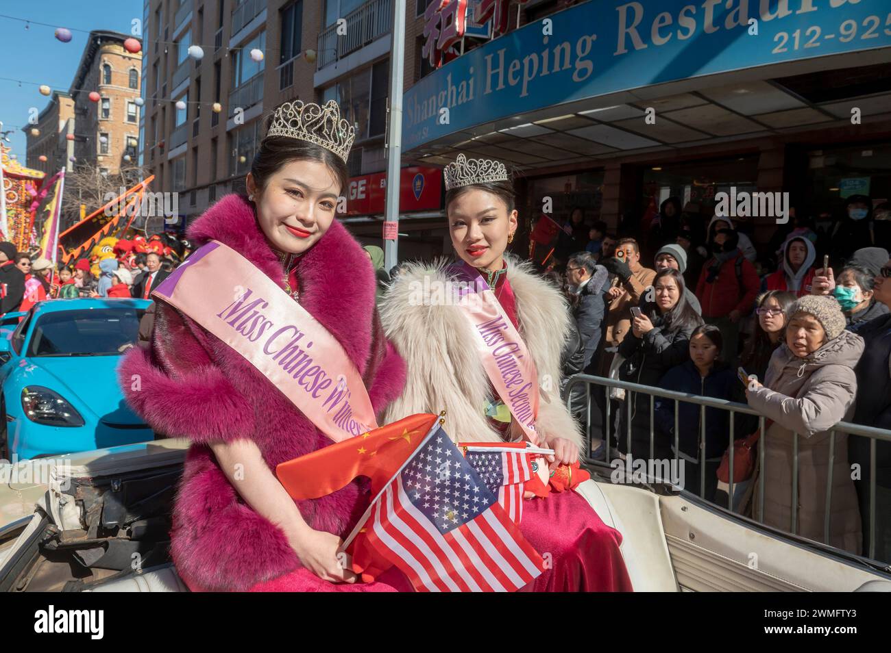 New York, United States. 25th Feb, 2024. 2023 Chinese beauty pageant winner Faye Liu and second runner up Kang Lai ride on a car at the annual Lunar New Year parade in Chinatown on February 25, 2024 in New York City. People gathered to enjoy and celebrate the 26th annual Lunar New Year parade, commemorating the end of the 15 days honoring the first new moon on the lunar calendar. 2024 is the 'Year of the Dragon.' (Photo by Ron Adar/SOPA Images/Sipa USA) Credit: Sipa USA/Alamy Live News Stock Photo