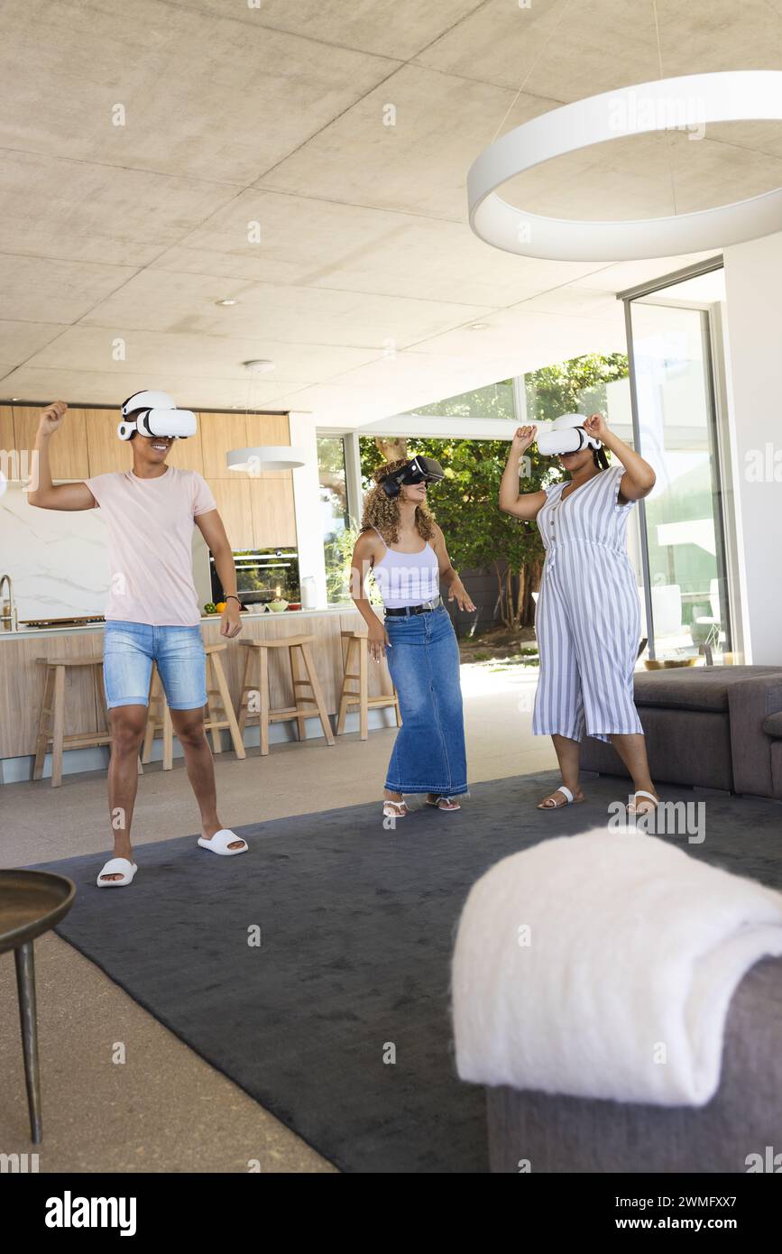 Diverse friends enjoy a virtual reality experience at home Stock Photo