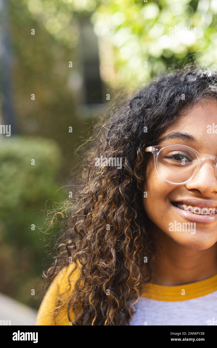 Teenage girl smiles brightly outdoors Stock Photo