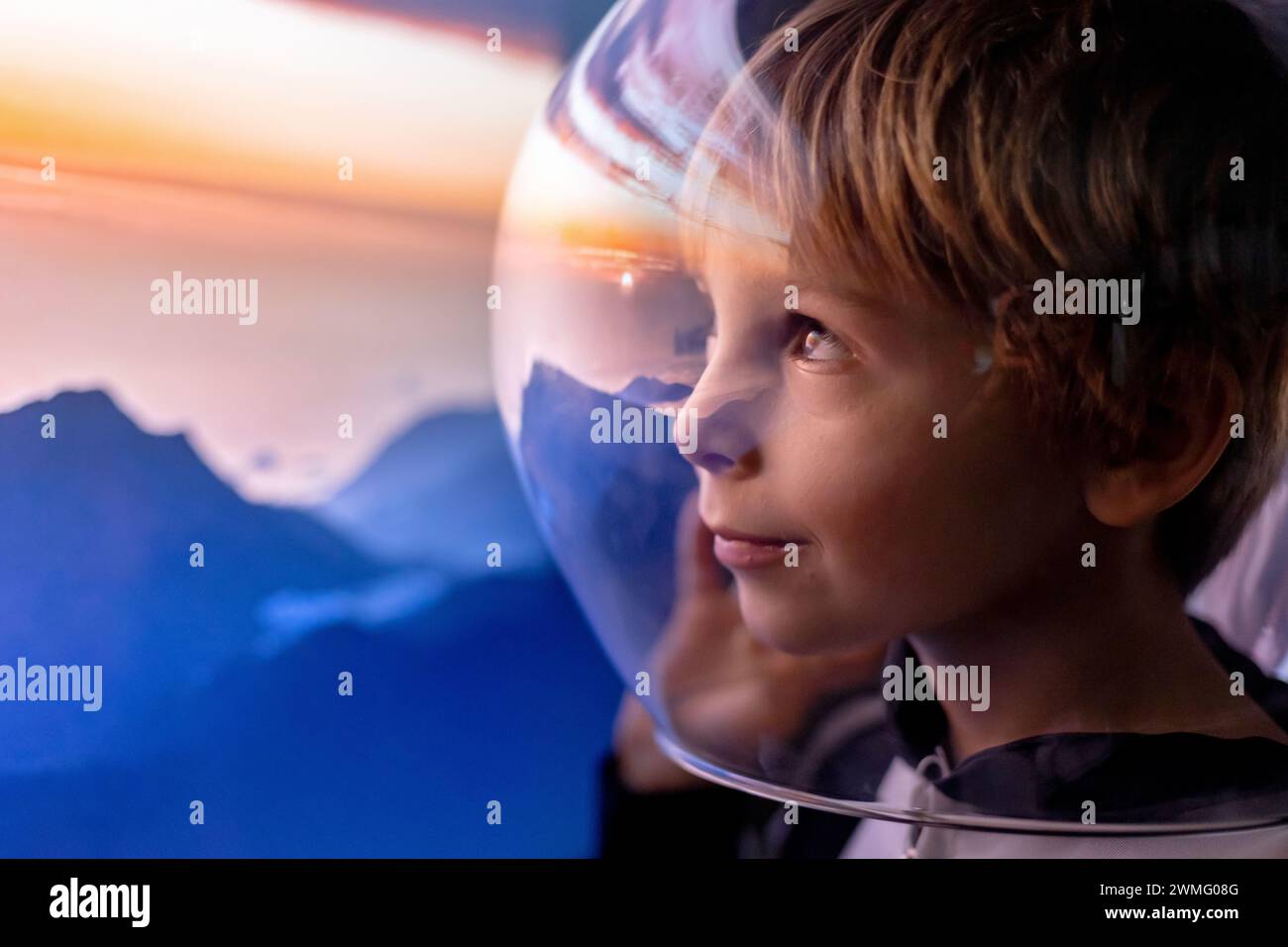 Cute child, boy, dreaming of becoming astronaut and flying into space. reflection of moon in his helmet Stock Photo