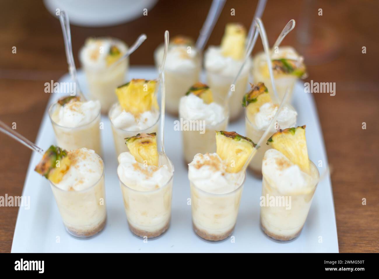 Dessert Table with Pineapple Decorations on a Wooden Table Stock Photo