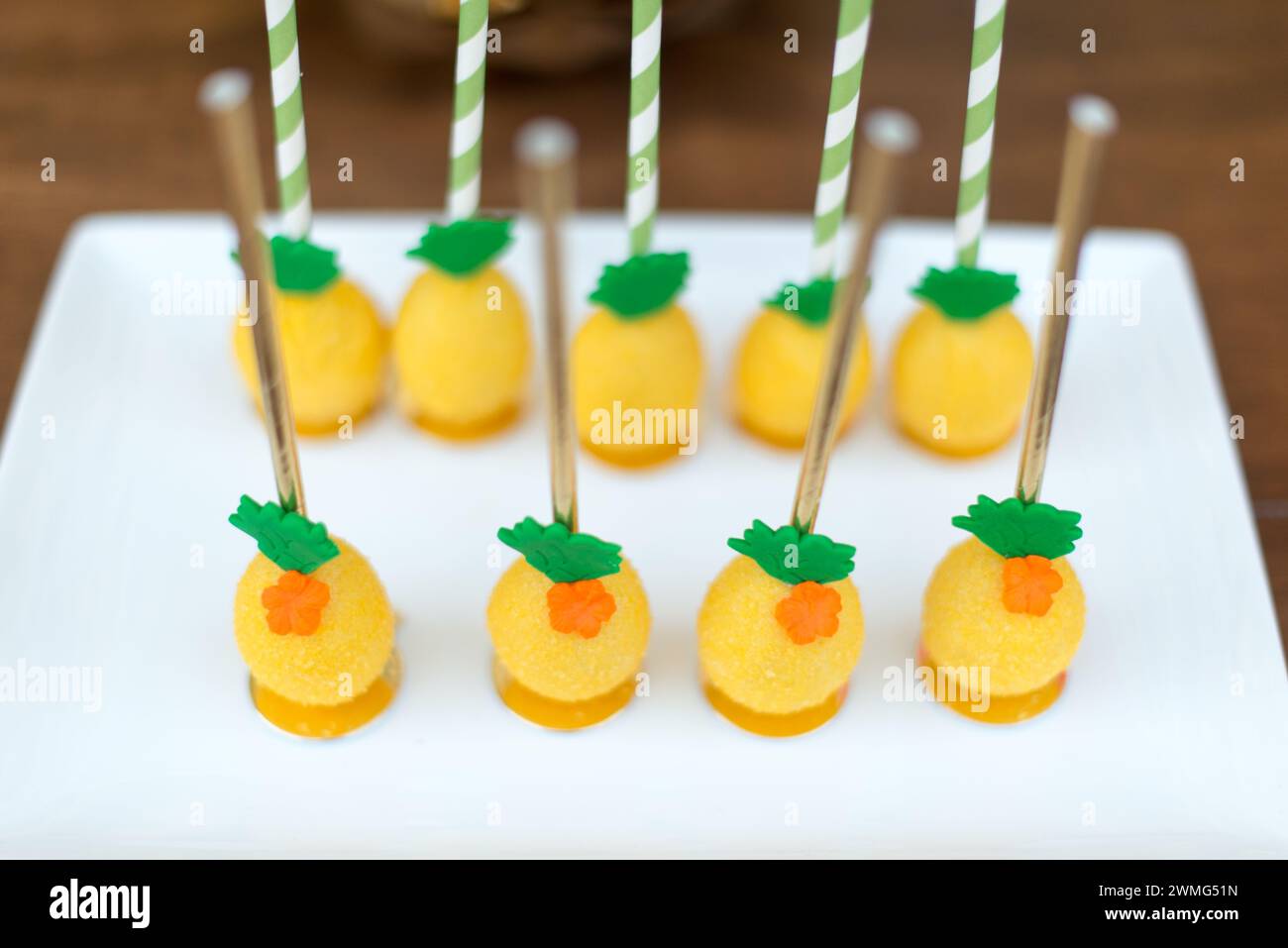 Pineapple Cake Pops on a Wooden Table Stock Photo