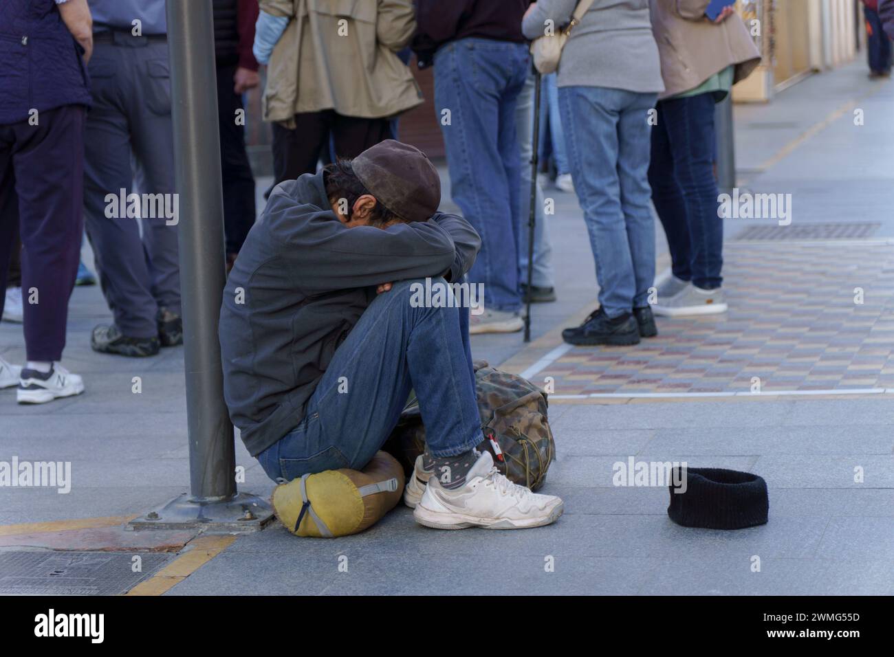homeless man on the street begging for alms Stock Photo