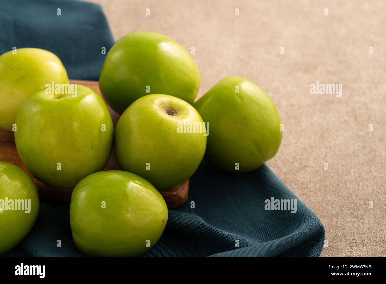 Fresh juicy delicious Taiwanese Milk Indian Jujube fruit in a basket on gray table background. Stock Photo
