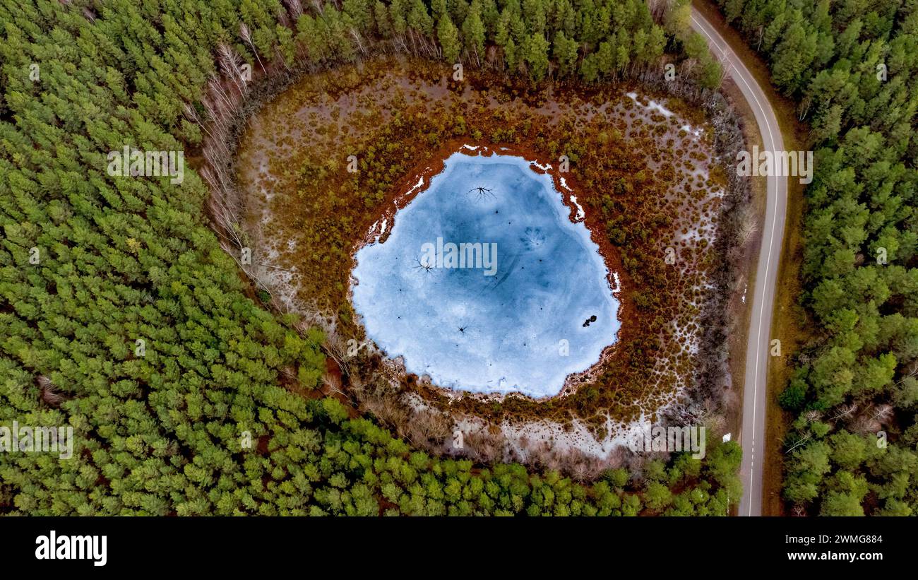 Aerial view of the lake in Lithuanian forests, wild winter nature. Name of the lake 'Samaninis', Varena district, Europe Stock Photo