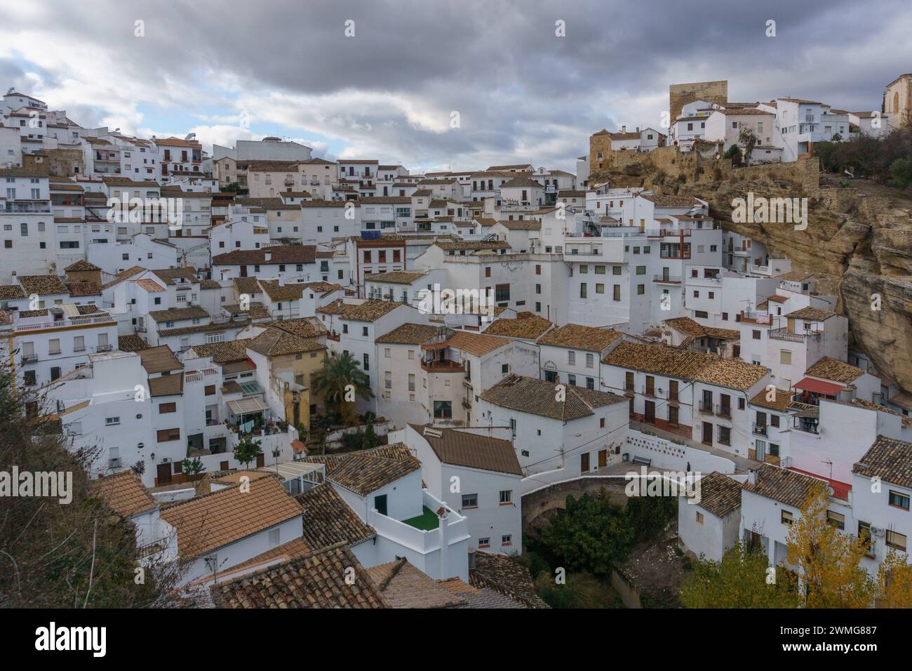 View over typical andalusian village with white houses and street with dwellings built into rock overhangs, Setenil de las Bodegas, Andalusia, Spain Stock Photo