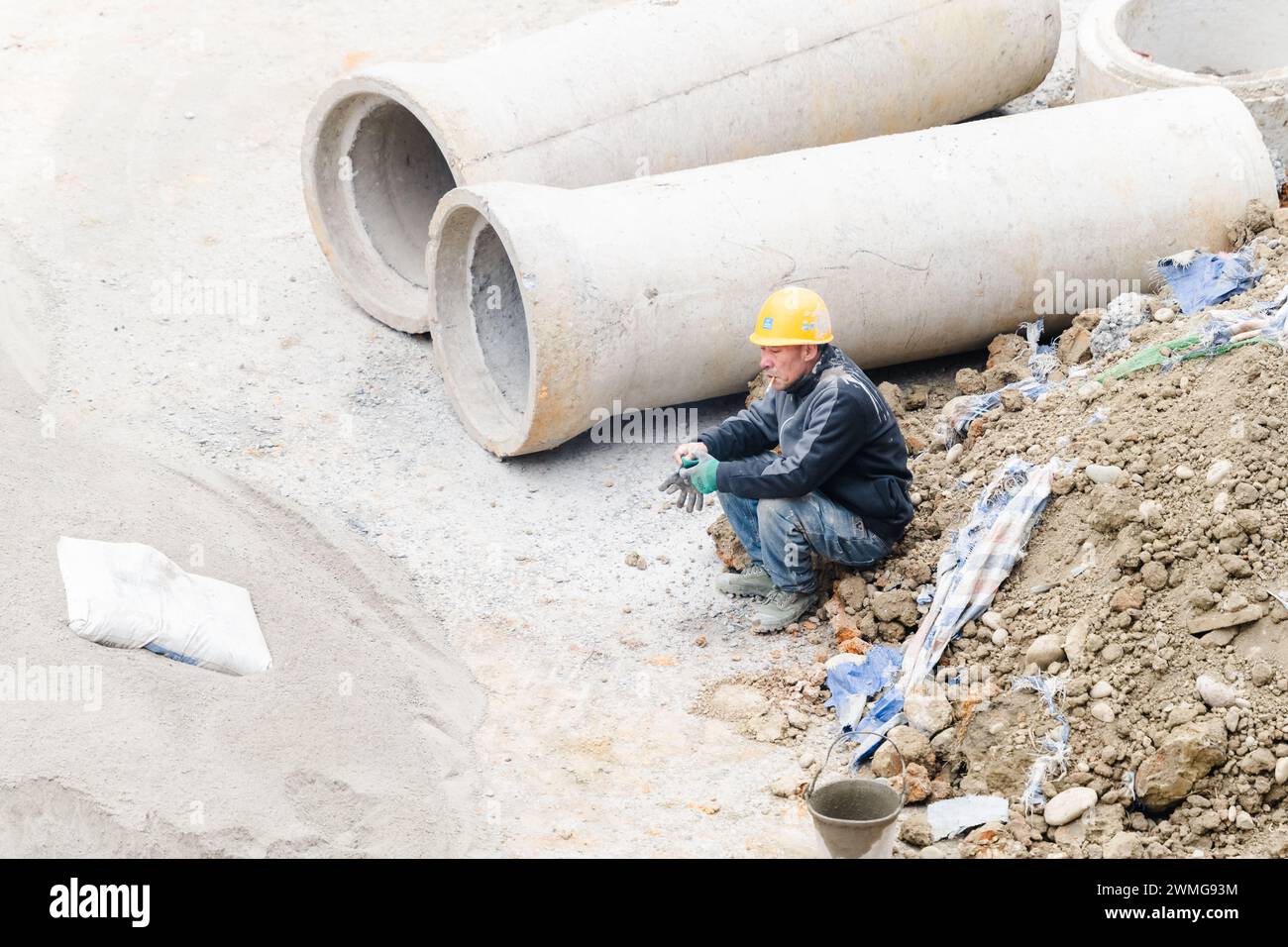 Workers taking a break and smoking at the construction site Stock Photo