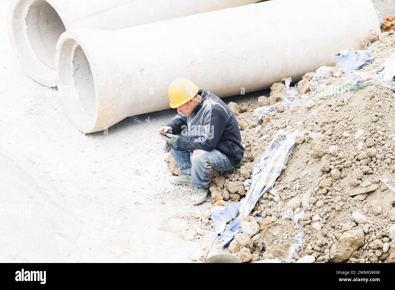 Workers taking a break and smoking at the construction site Stock Photo