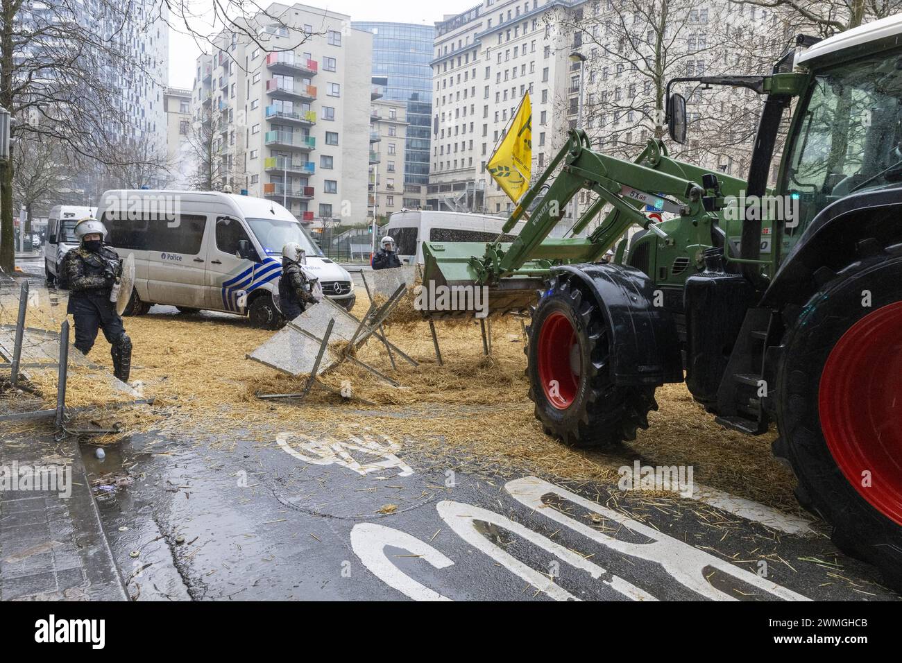 Brussels, Belgium. 26th Feb, 2024. a tractor breaks true the police barricade during a protest action of farmers' organizations 'Federation Unie de Groupements d'Eleveurs et d'Agriculteurs' (FUGEA), Boerenforum and MAP, organized in response to the European Agriculture Council, in Brussels, Monday 26 February 2024. Farmers continue their protest across Europe as they demand better conditions to grow, produce and maintain a proper income. BELGA PHOTO NICOLAS MAETERLINCK Credit: Belga News Agency/Alamy Live News Stock Photo