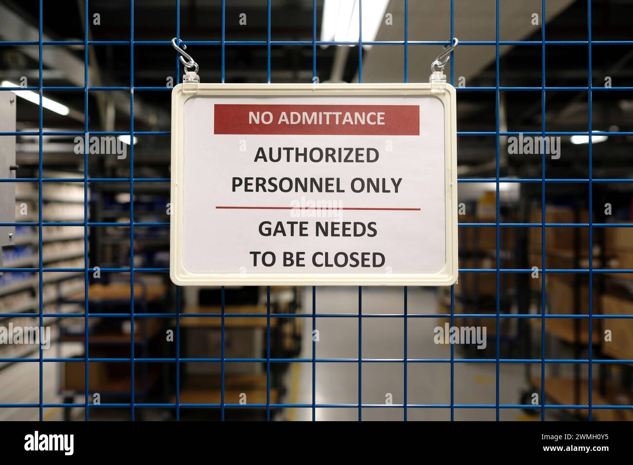 No admittance sign at a closed gate in a warehouse Stock Photo