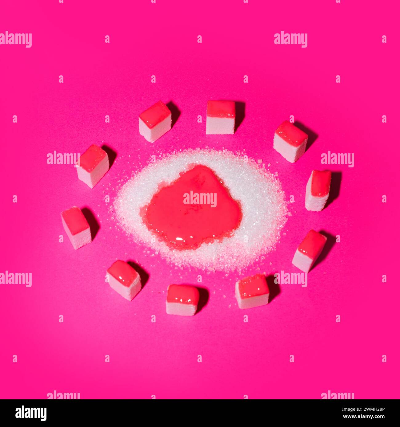 Sugar cubes surrounding sugar on a pink background. Crowd as food creative concept. Stock Photo