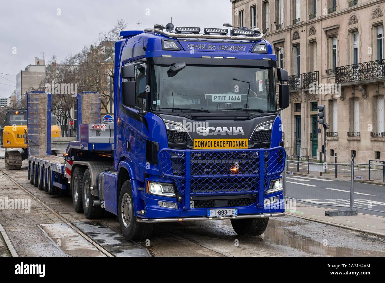 Nancy, France - Blue heavy haulage truck Scania R650 with an empty trailer on the road. Stock Photo
