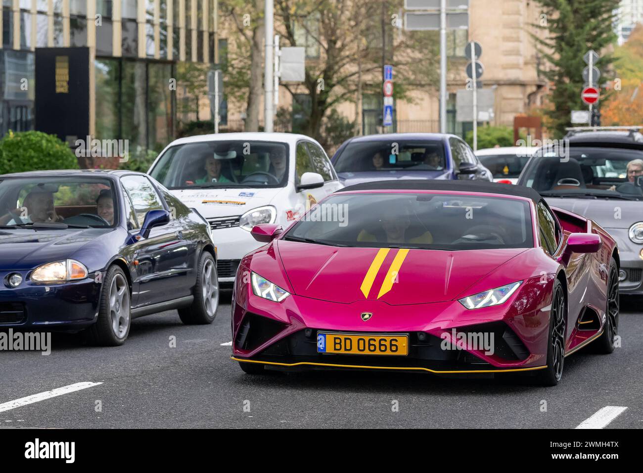 Luxembourg City, Luxembourg - Focus on a pink Lamborghini Huracán EVO RWD Spyder driving in a street. Stock Photo