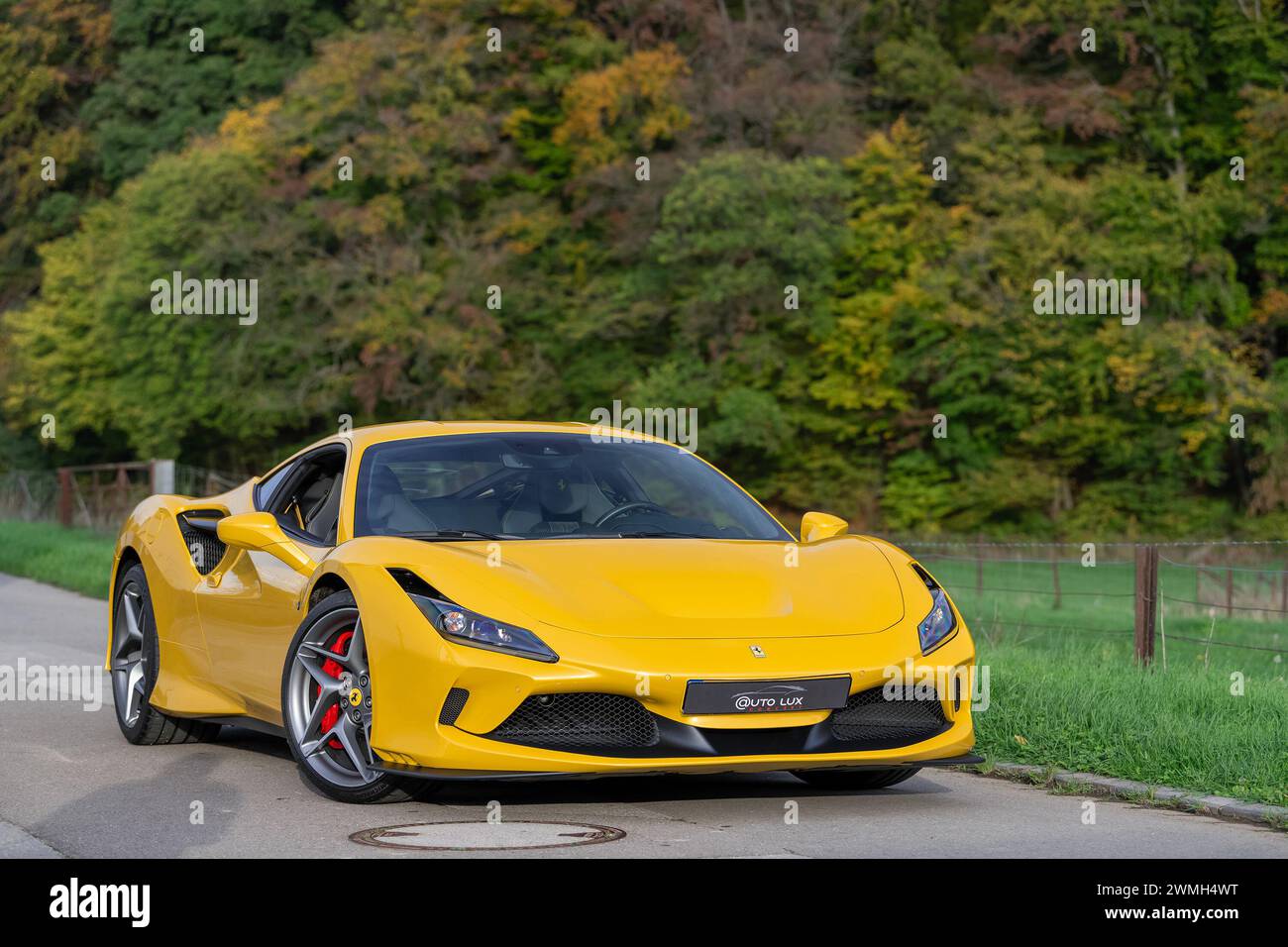 Luxembourg City, Luxembourg - Focus on a Giallo Triplo Strato Ferrari F8 Tributo parked in a street in the countryside. Stock Photo