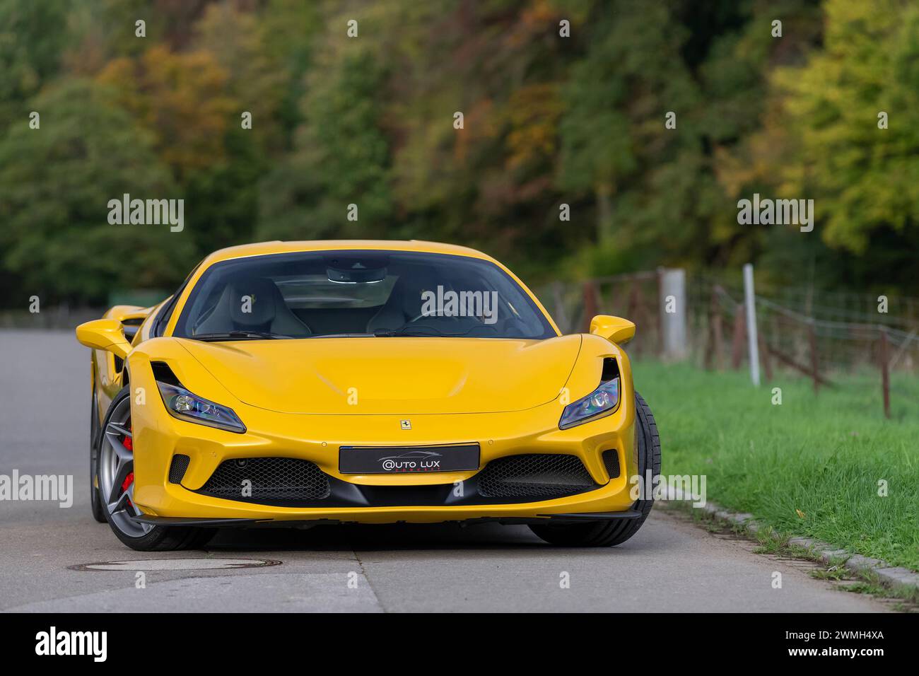 Luxembourg City, Luxembourg - Focus on a Giallo Triplo Strato Ferrari F8 Tributo parked in a street in the countryside. Stock Photo