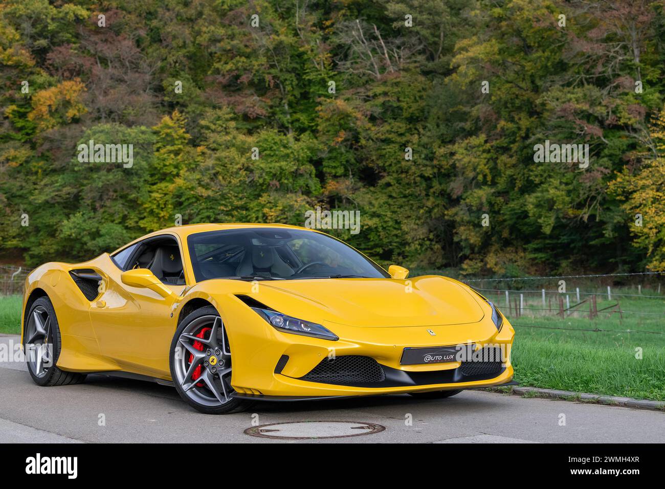 Luxembourg City, Luxembourg - Focus on a Giallo Triplo Strato Ferrari F8 Tributo parked in a street in the countryside. Stock Photo