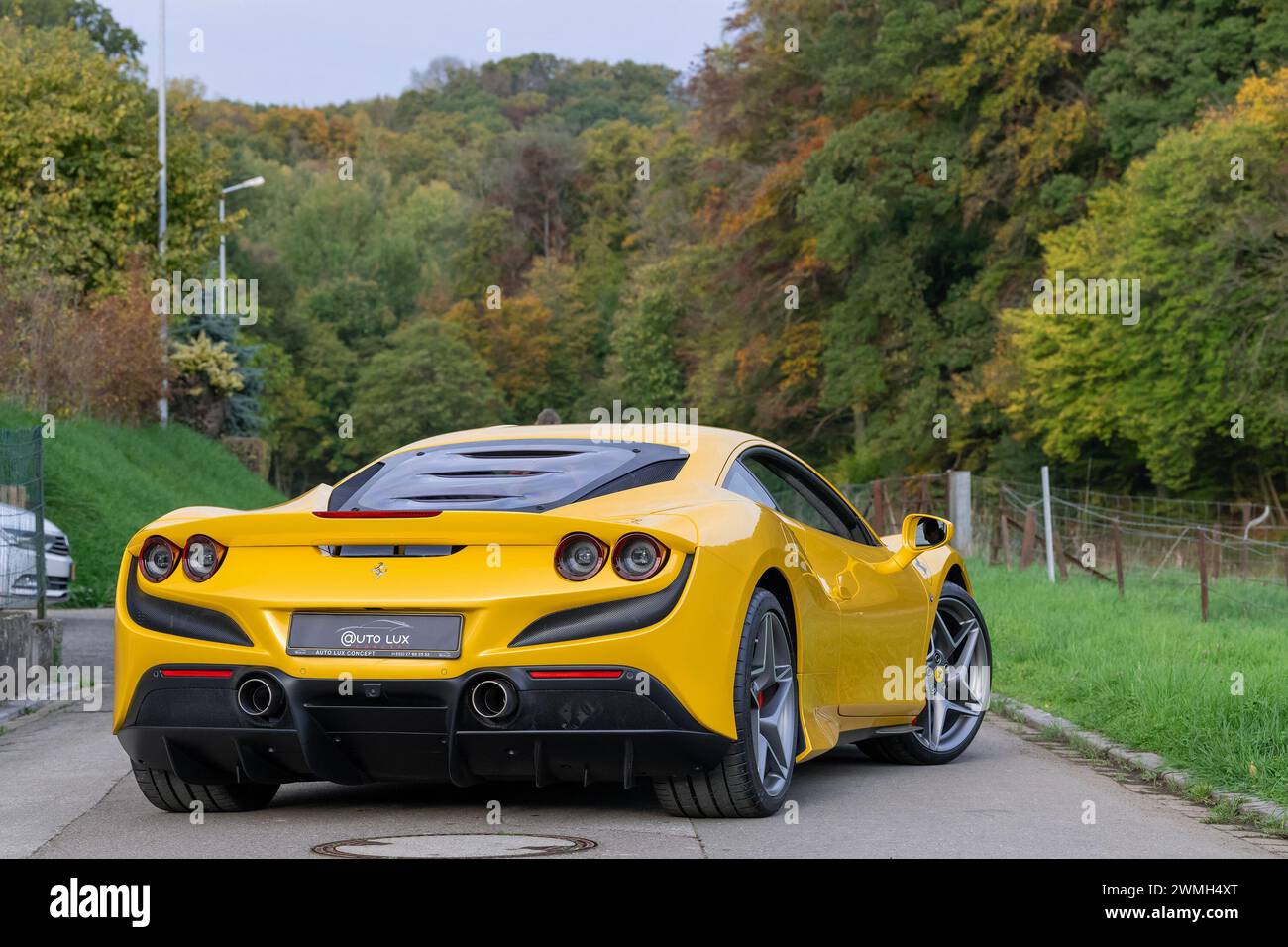 Luxembourg City, Luxembourg - Focus on a Giallo Triplo Strato Ferrari F8 Tributo parked in a street in the countryside. Stock Photo