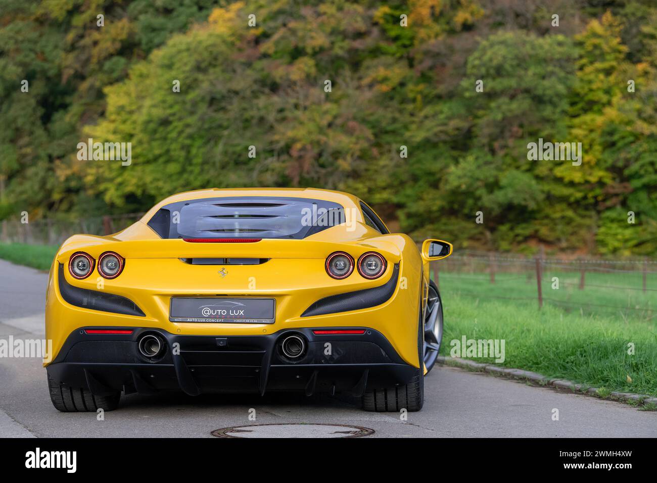 Luxembourg City, Luxembourg - Focus on a Giallo Triplo Strato Ferrari F8 Tributo parked in a street in the countryside. Stock Photo