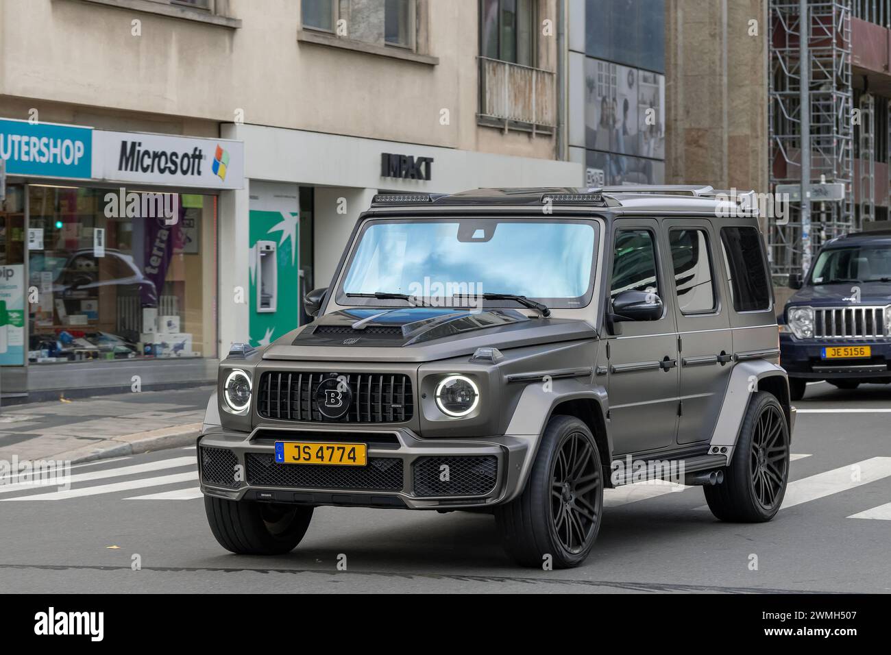 Luxembourg City, Luxembourg - Focus on a matte brown Mercedes-AMG G 63 Brabus driving in a street. Stock Photo