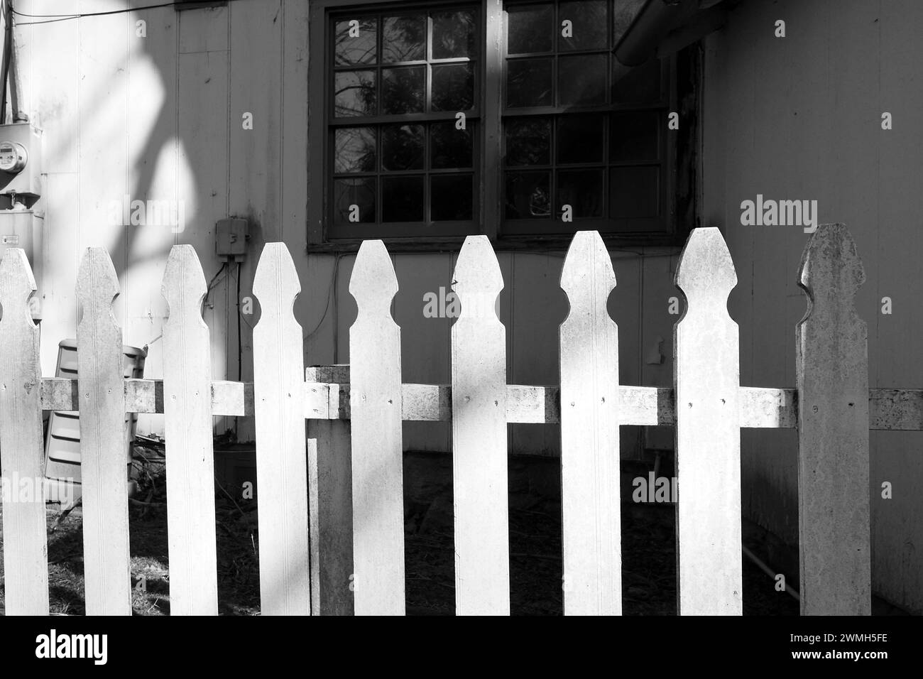 The white picket fence protects the property. Stock Photo