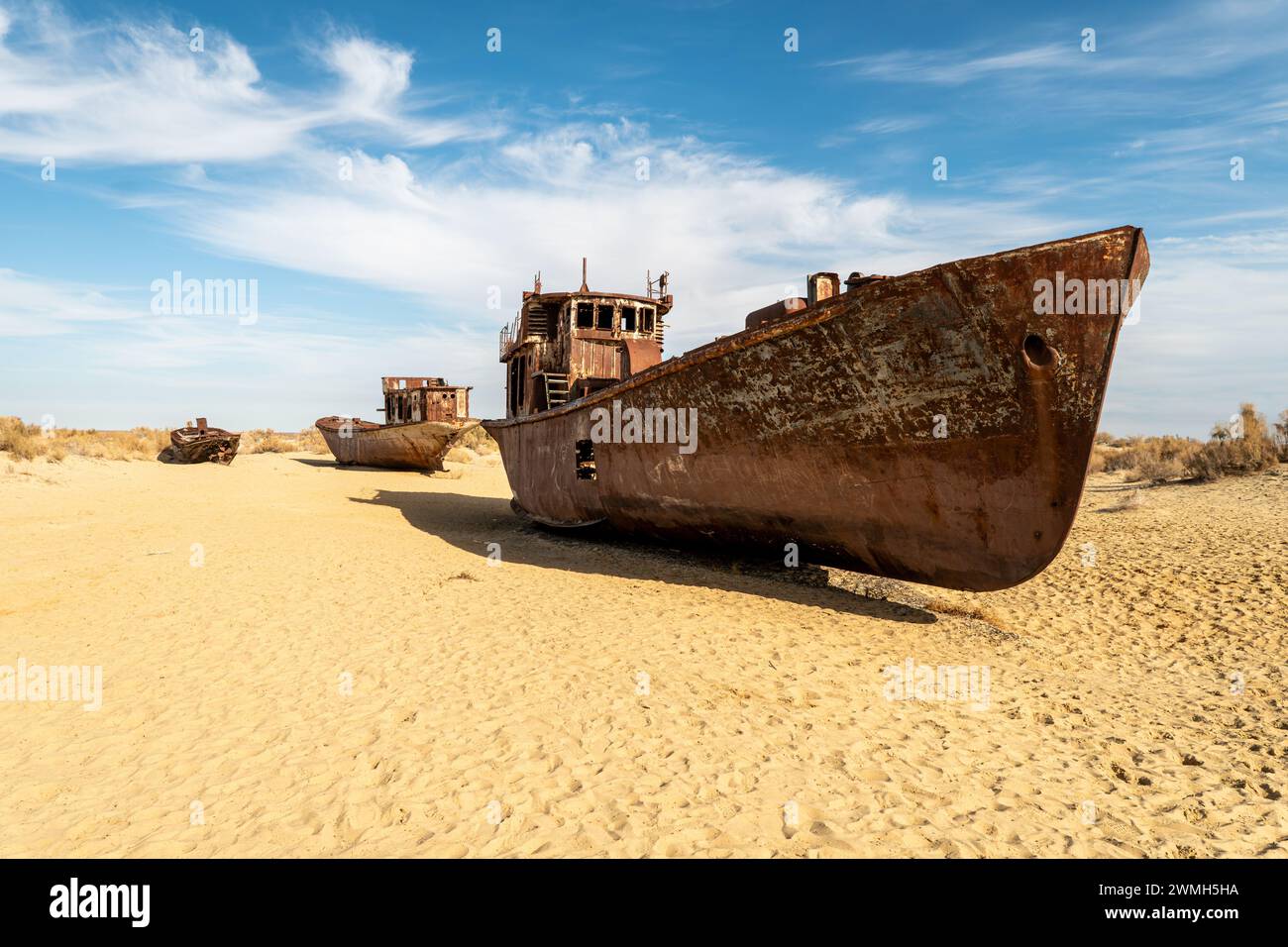 A rusty ship at the bottom of the former Aral Sea. The dried-up sea in an environmental disaster and climate change in Central Asia. the problems of g Stock Photo