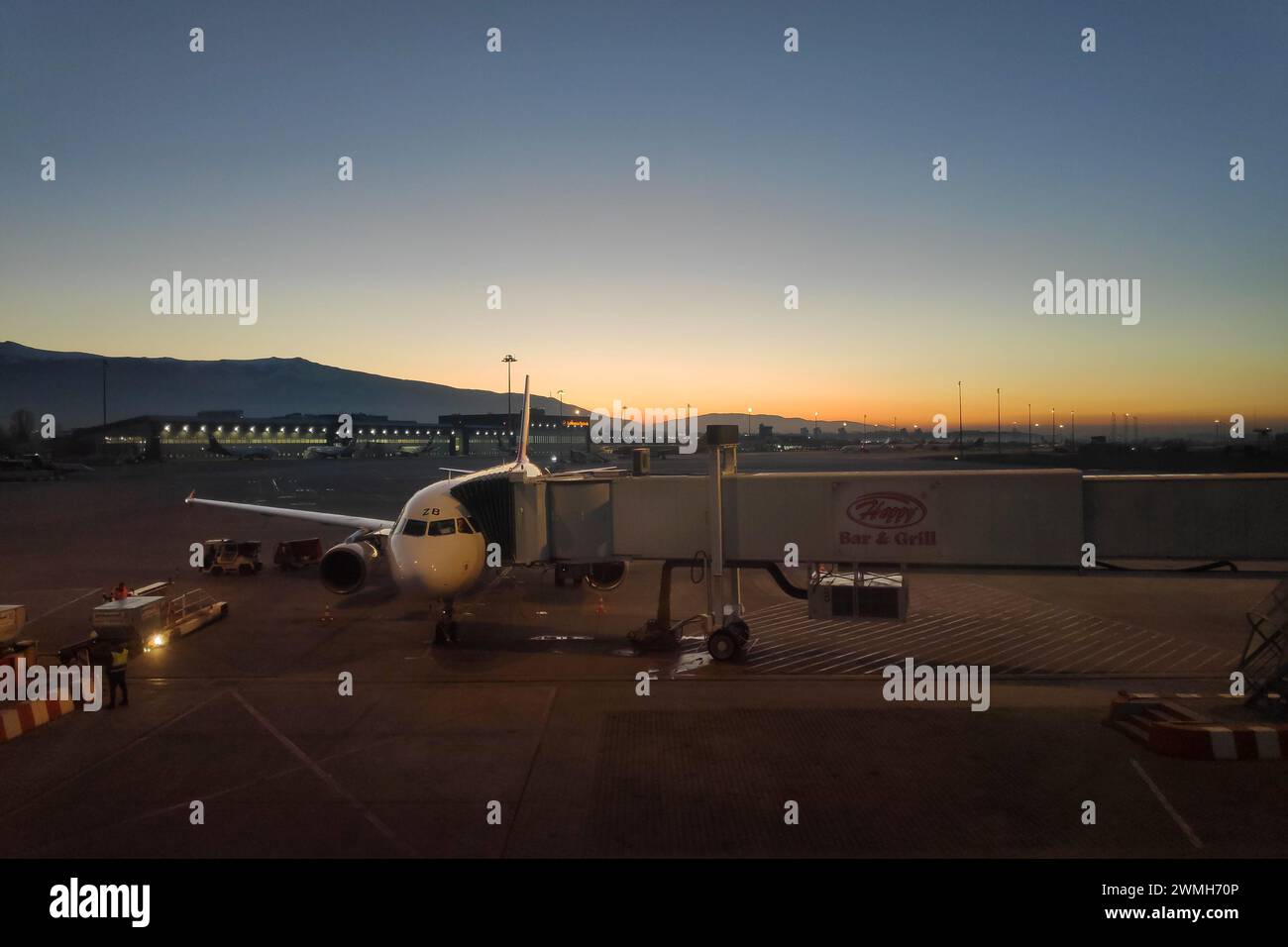 Sofia, Bulgaria - January 31 2024: Plane landing at Sofia airport at dusk. Stock Photo