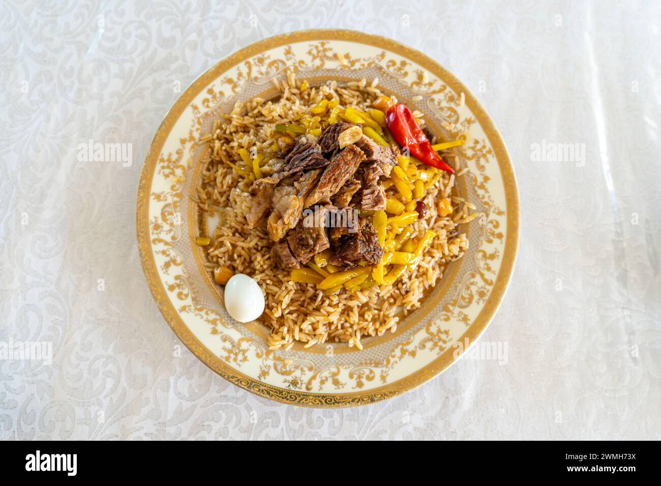 top view The concept of oriental cuisine. Uzbek food pilaf asia food. Homemade Uzbek pilaf or plov from lamb. view from above Stock Photo